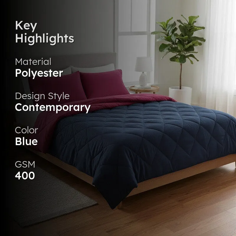 Blue quilted comforter styled on a bed in a contemporary bedroom