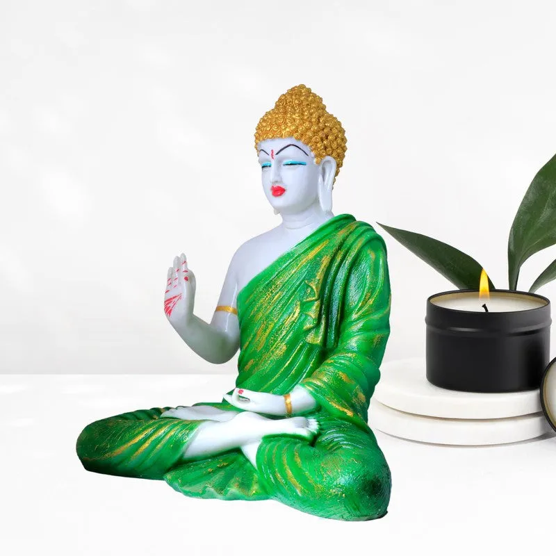 Angled view of Buddha idol in green robe with gold accents
