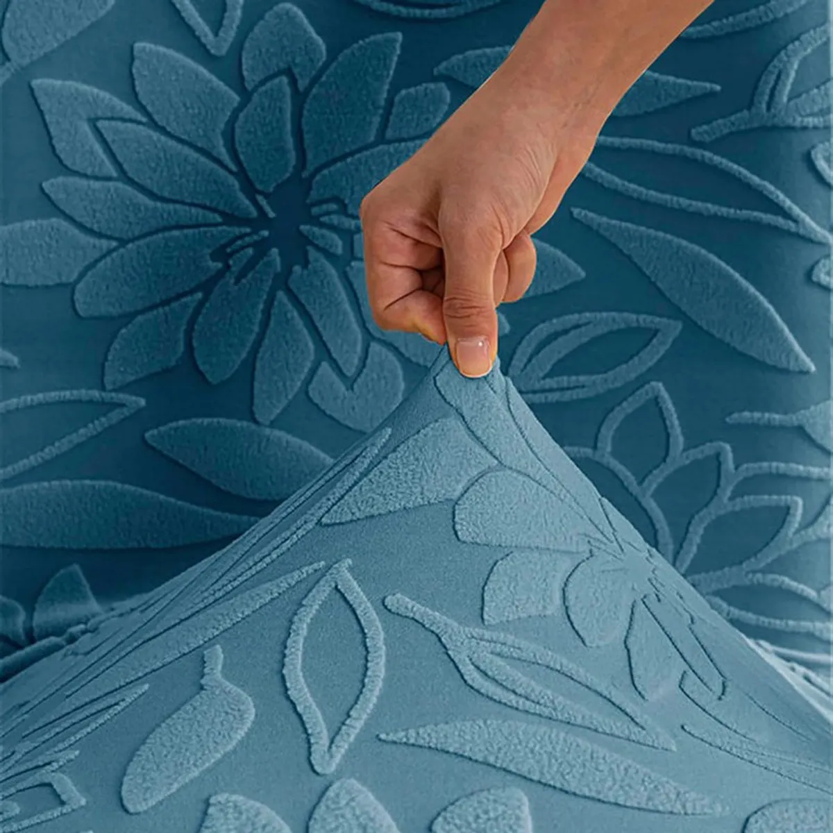 Close-up of the raised floral texture on a light blue chair cover
