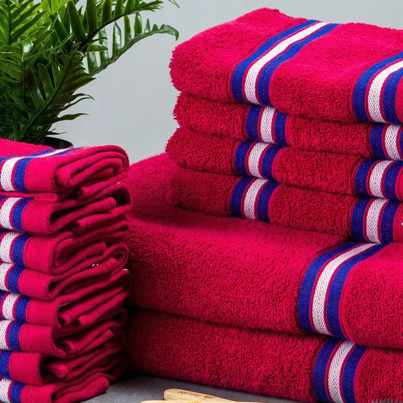 Close-up of plush pink towels with contrasting blue and white striped bands.