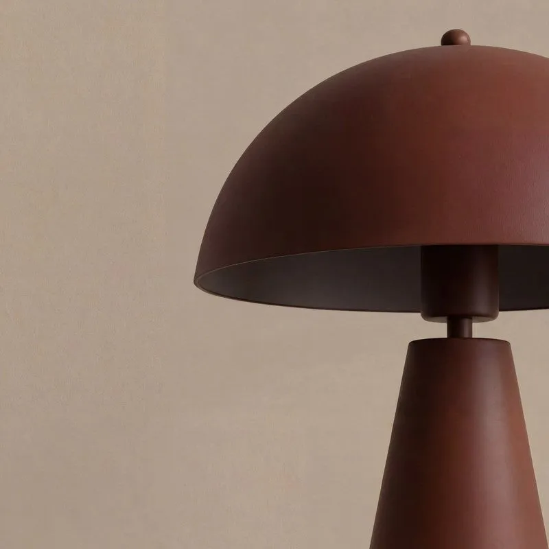 Side close-up of the brown metal table lamp shade and tapered base