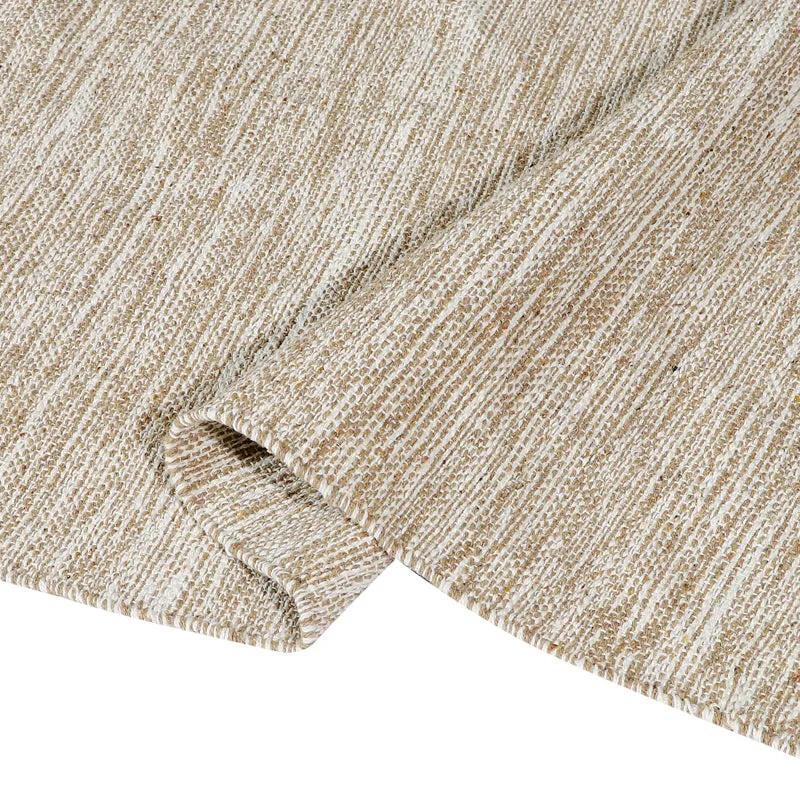 Folded corner detail of the beige textured runner rug