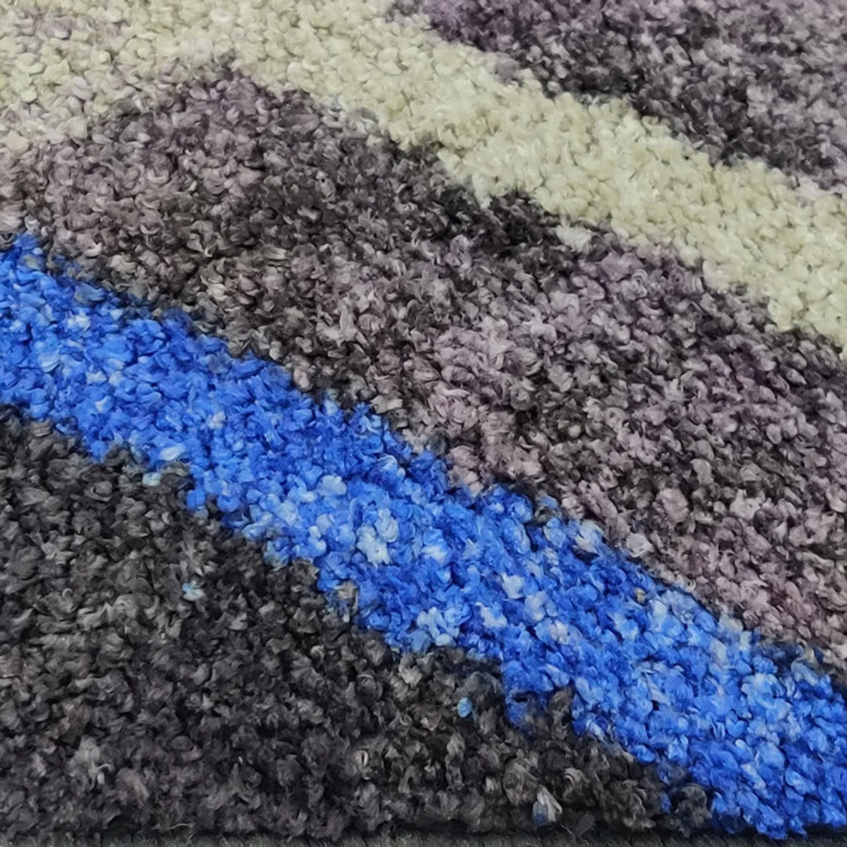 Close-up of blue accent stripe on the textured runner rug surface