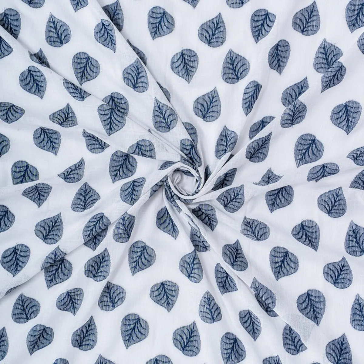 Close-up of lightweight grey curtain fabric with blue leaf motifs.