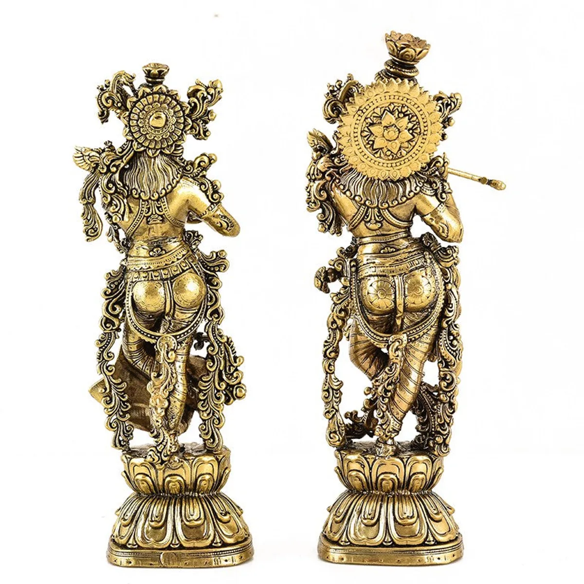 Back view of two ornate gold-toned Venugopala idols with detailed decoration