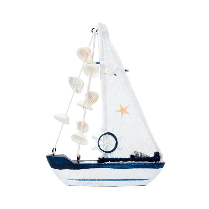Front view of a white and blue sailboat showpiece with net sail and shells