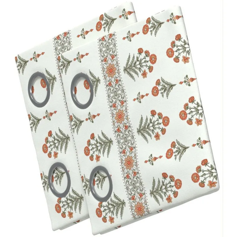 Folded curtain fabric showing an off-white floral print and metal eyelets