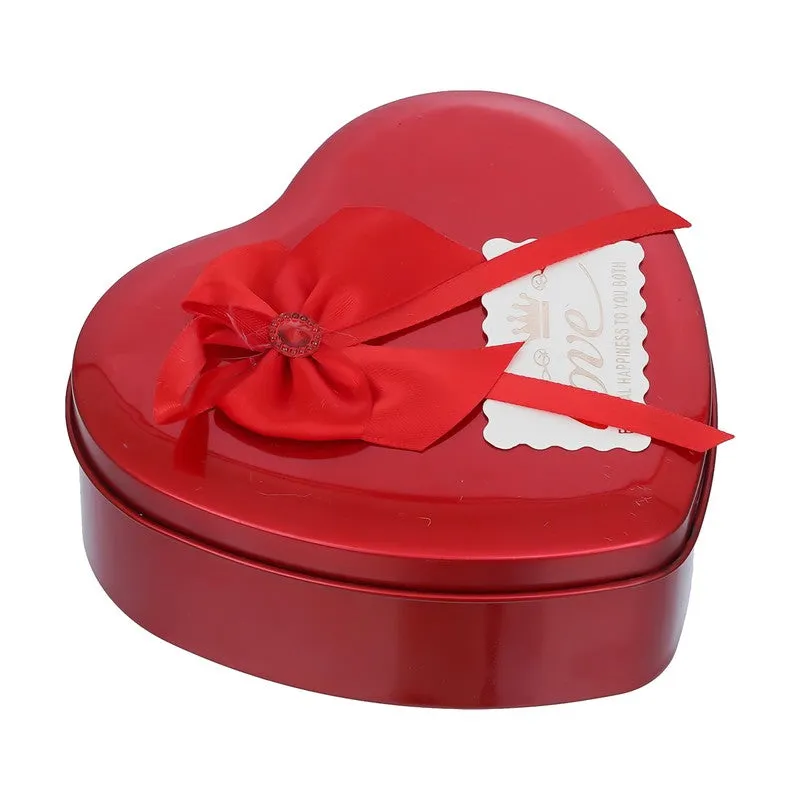 Closed red heart-shaped gift box with red ribbon bow