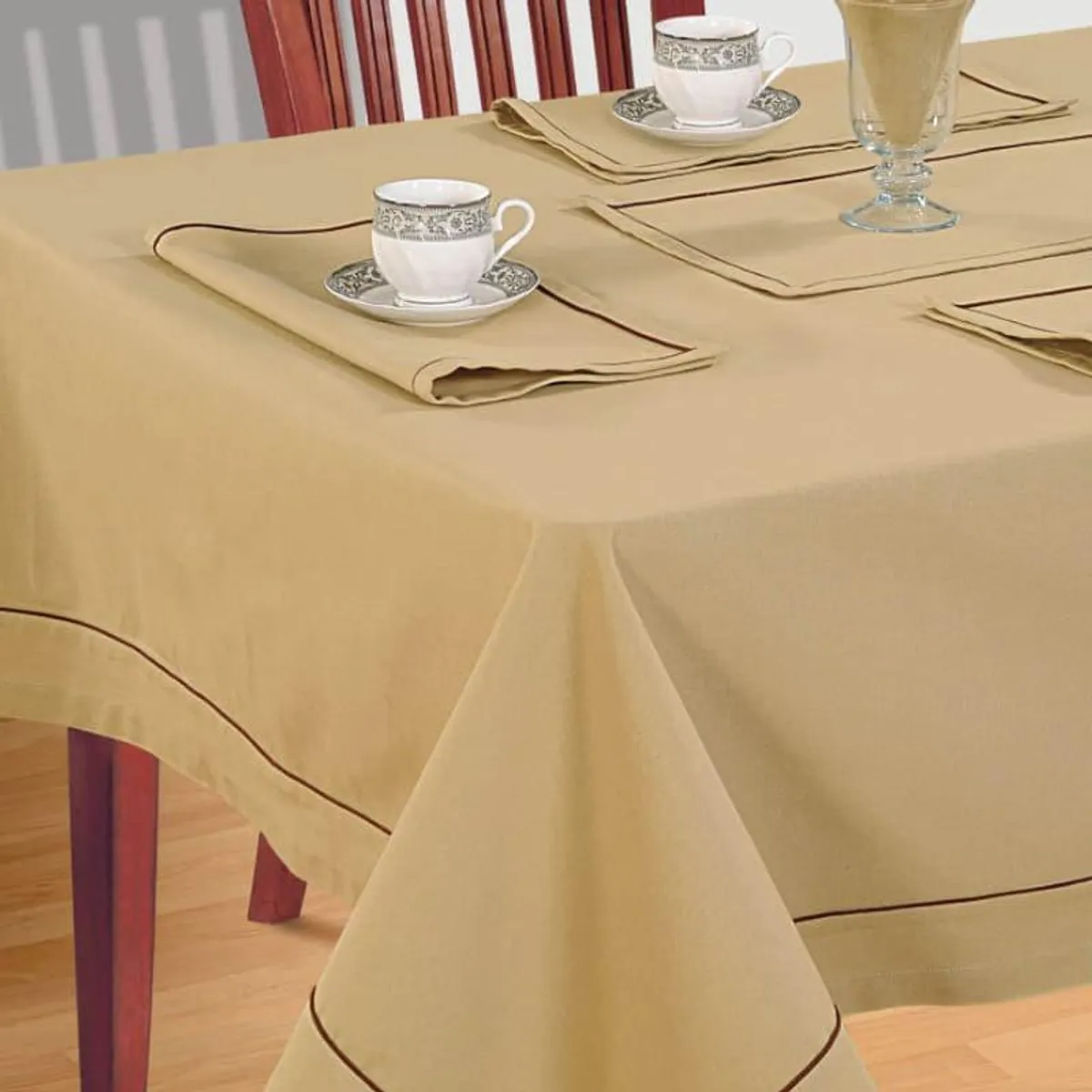 Close view of beige table cover with brown trim on a dining table