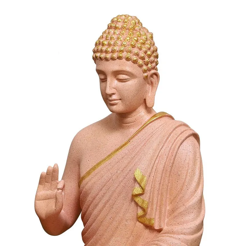 Close-up of the peach Buddha idol showing the face and robe detailing