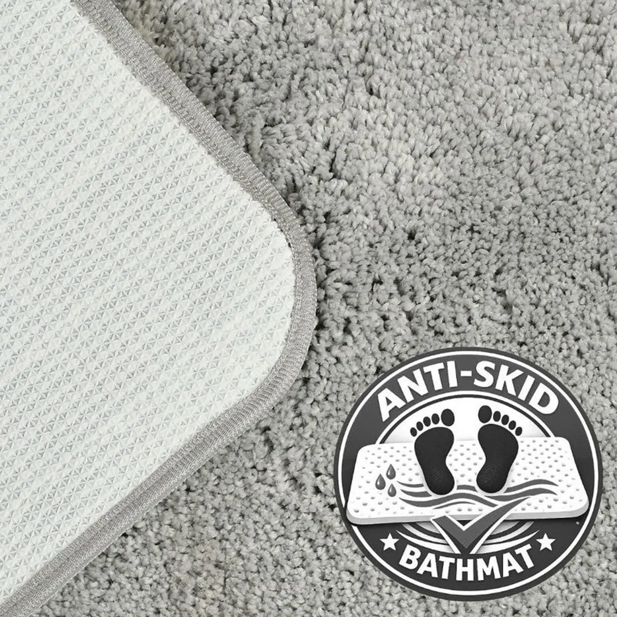 Corner of grey bath mat showing anti-skid backing texture