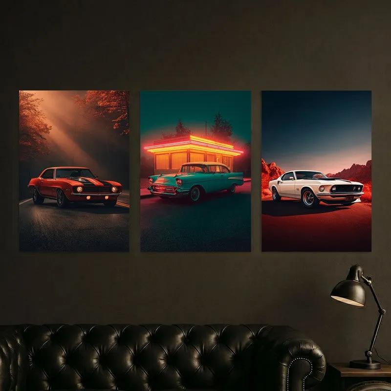 Three vintage car posters styled above a dark sofa and lamp