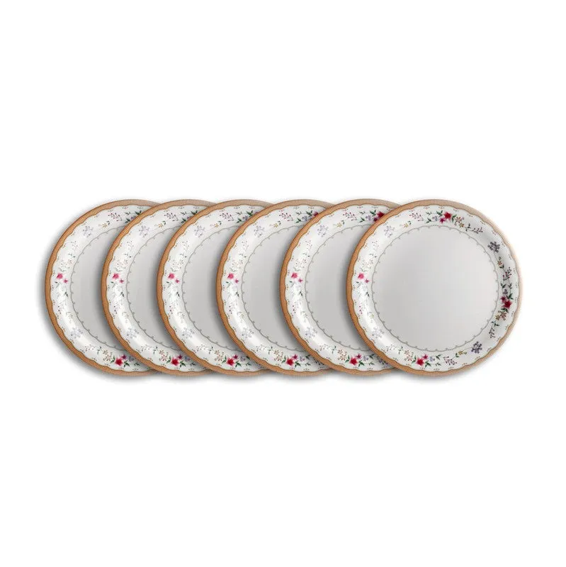 Six matching white floral dinner plates arranged in an overlapping row