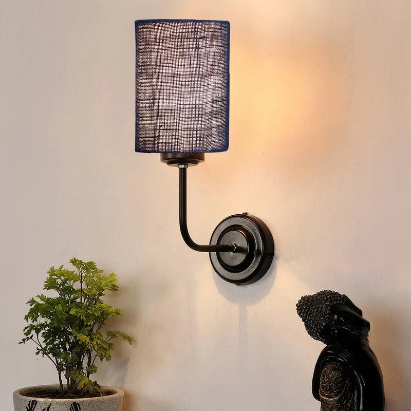 Lit blue jute wall lamp with black iron base mounted on a wall
