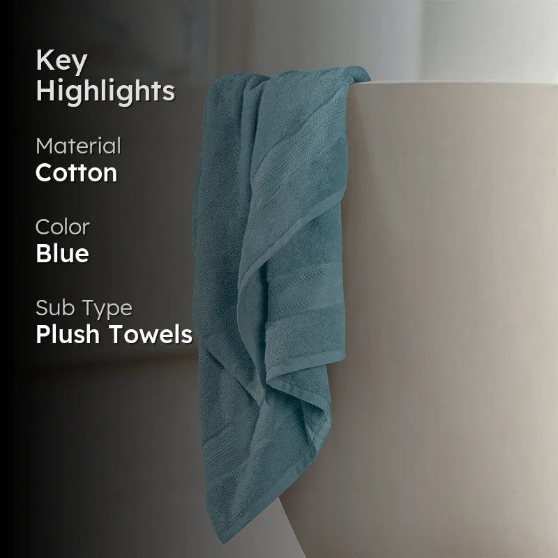 Blue bath towel draped over a bathroom surface in a close-up setting