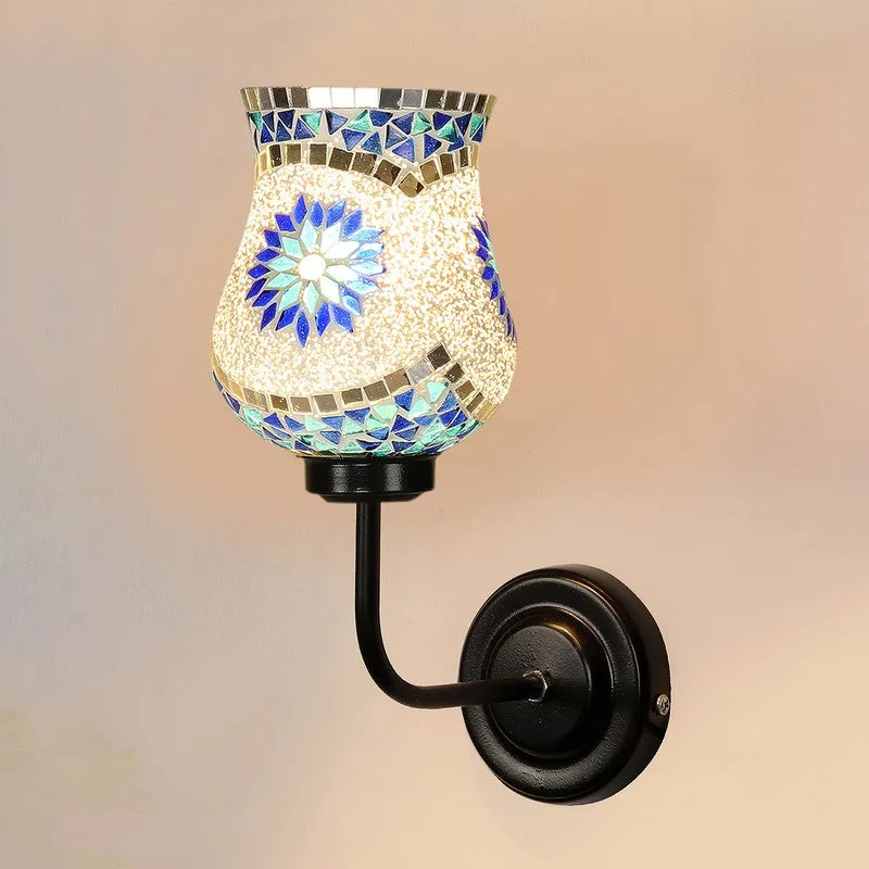 Close-up wall lamp with mosaic glass shade and curved black iron arm