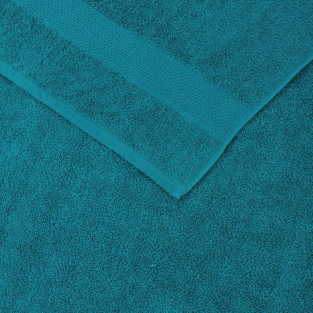 Close-up of the teal towel showing its textured solid design