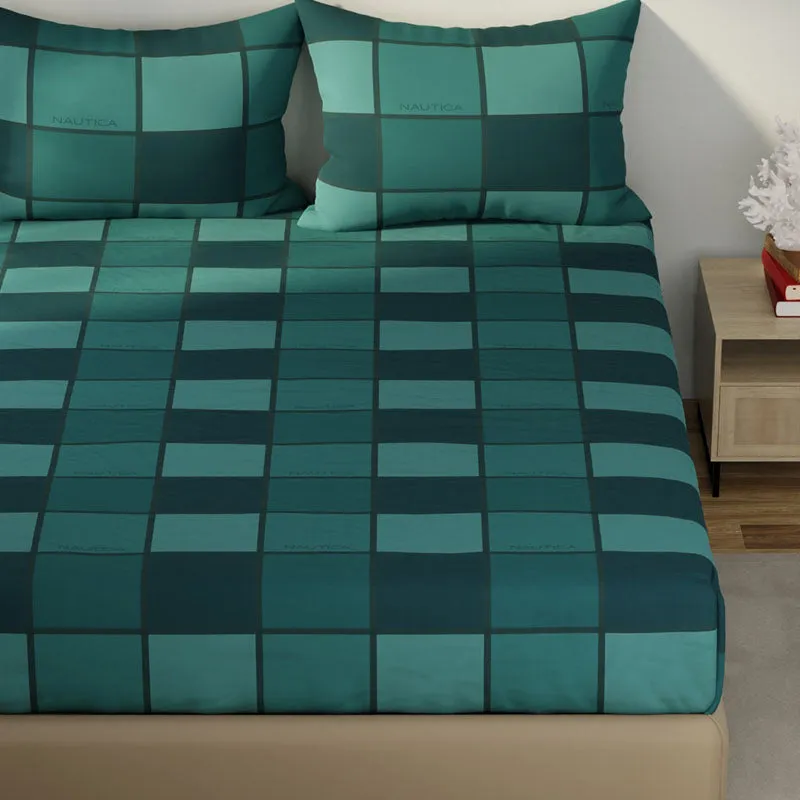 Close view of green checked bedsheet spread across a bed