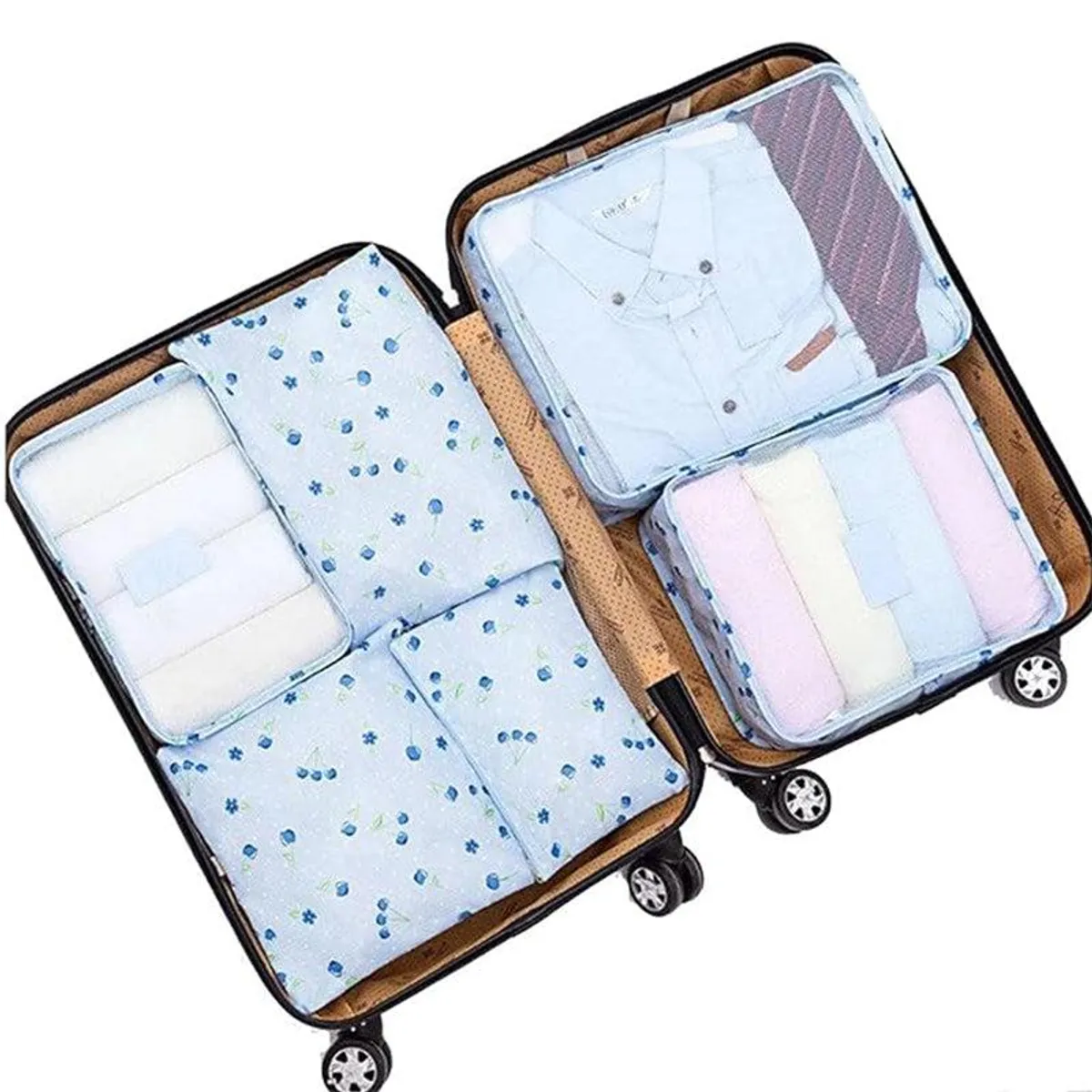 Blue floral travel organisers packed with folded clothing inside an open suitcase.