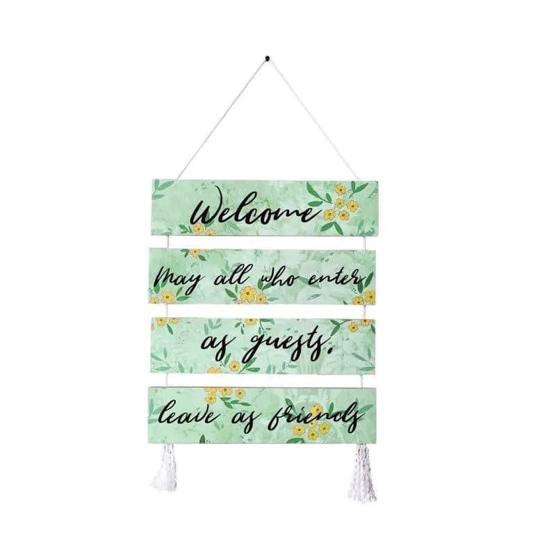Front view of a floral wall hanging with four pale green panels and tassels