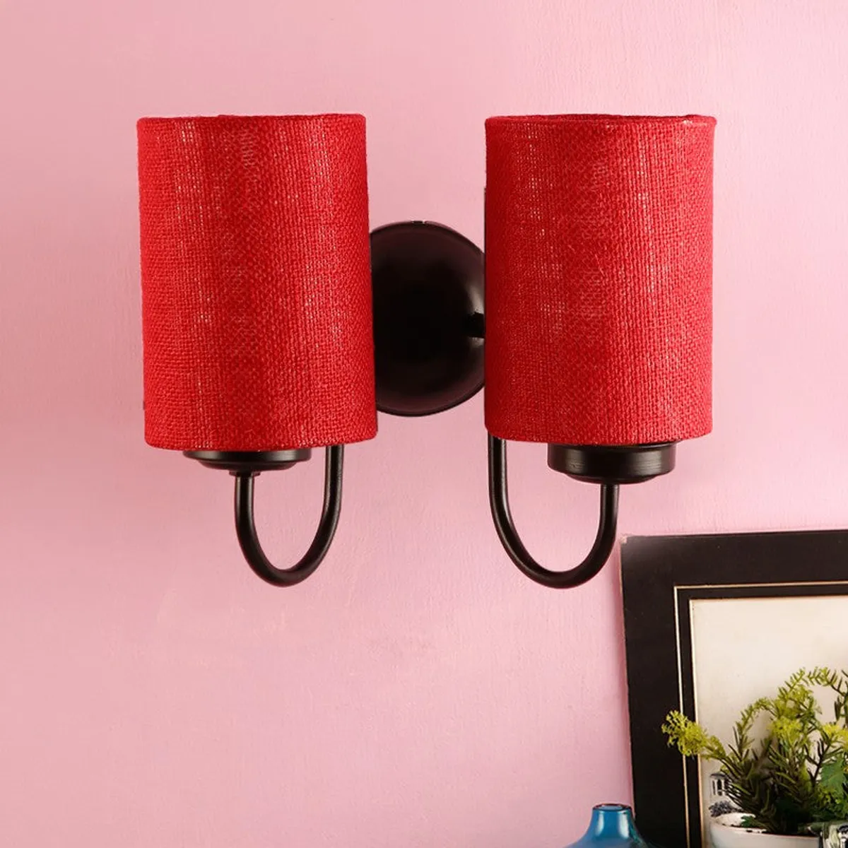 Red double wall lamp with cylindrical jute shades on black mount