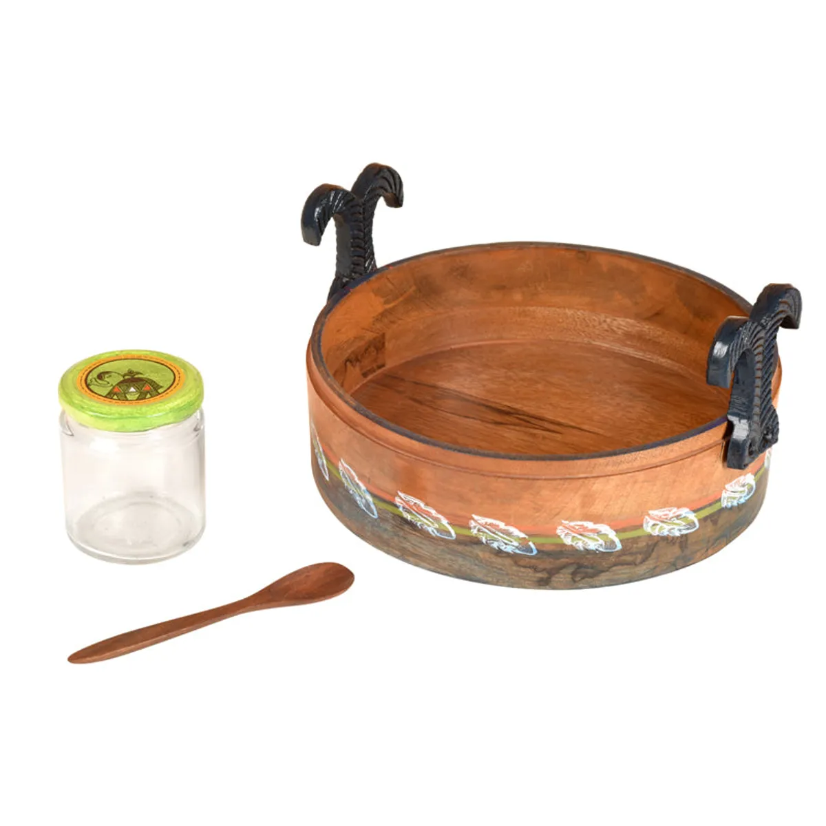 Empty decorated wooden bowl with one glass jar and a wooden spoon