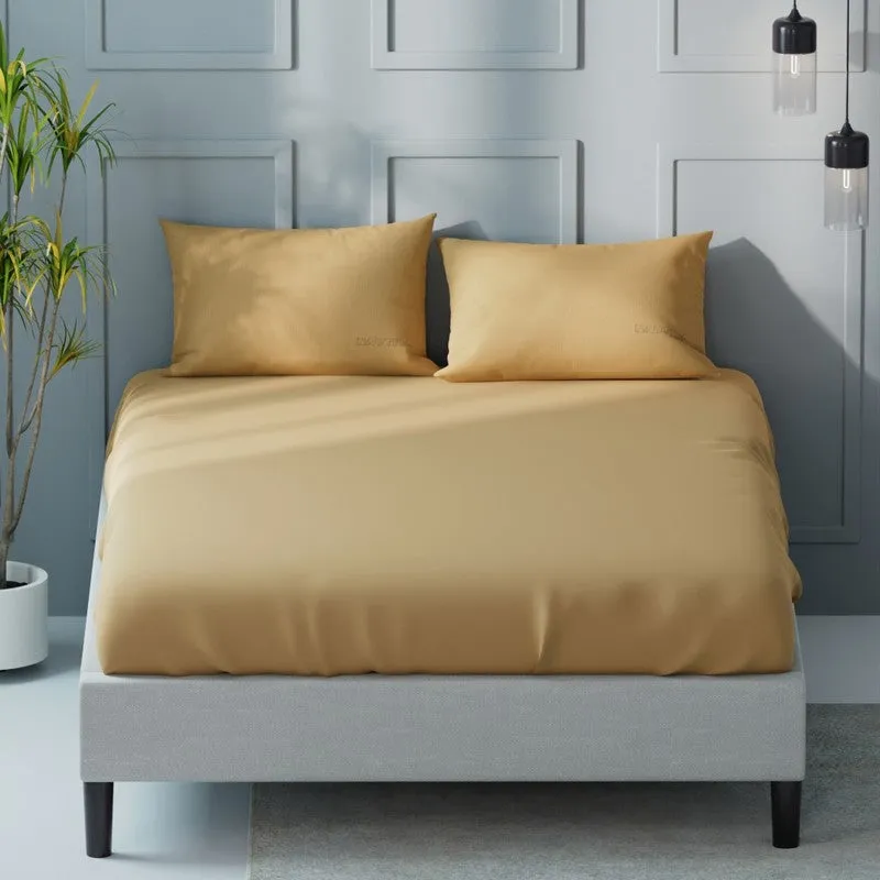 Front view of a mustard-yellow solid bedsheet and two matching pillow covers