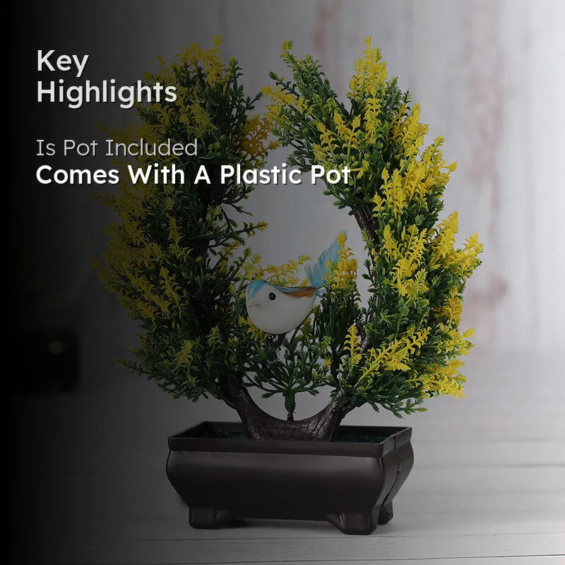 Yellow and green artificial plant with a bird in a black pot in a room setting