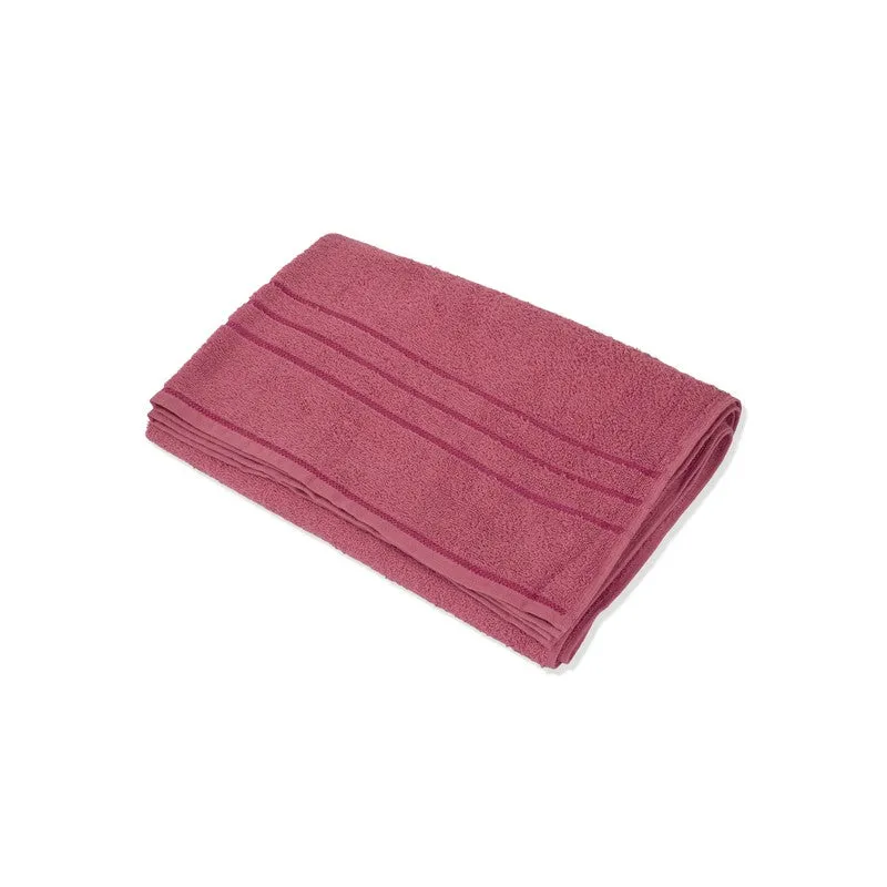 Folded dusty pink bath towel on a white background