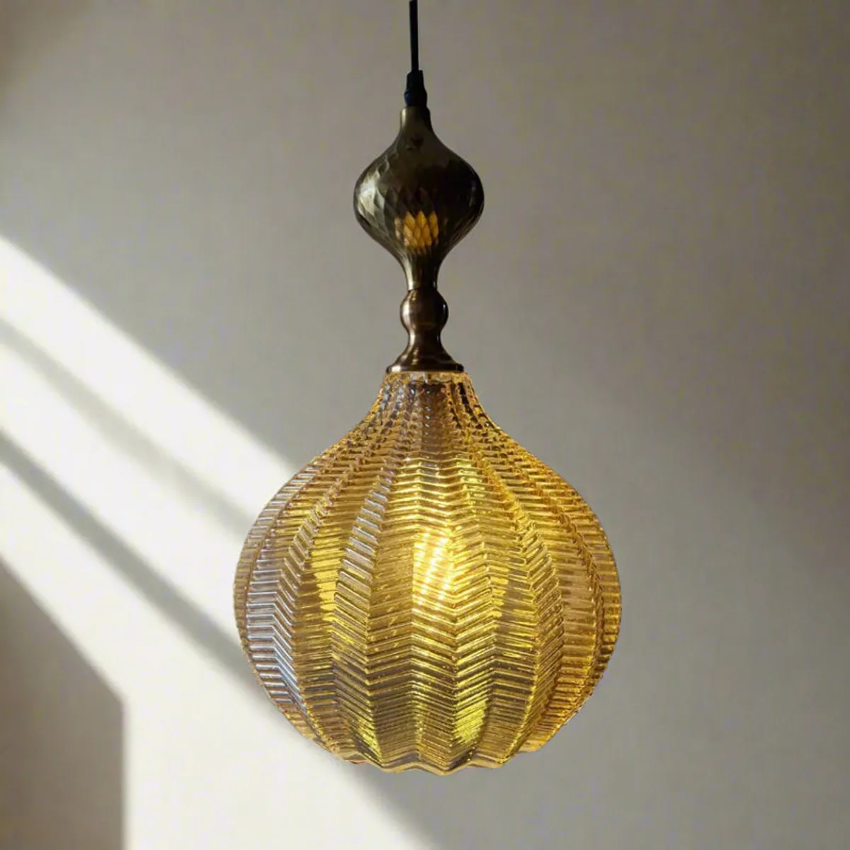Close-up of a gold textured glass pendant ceiling lamp