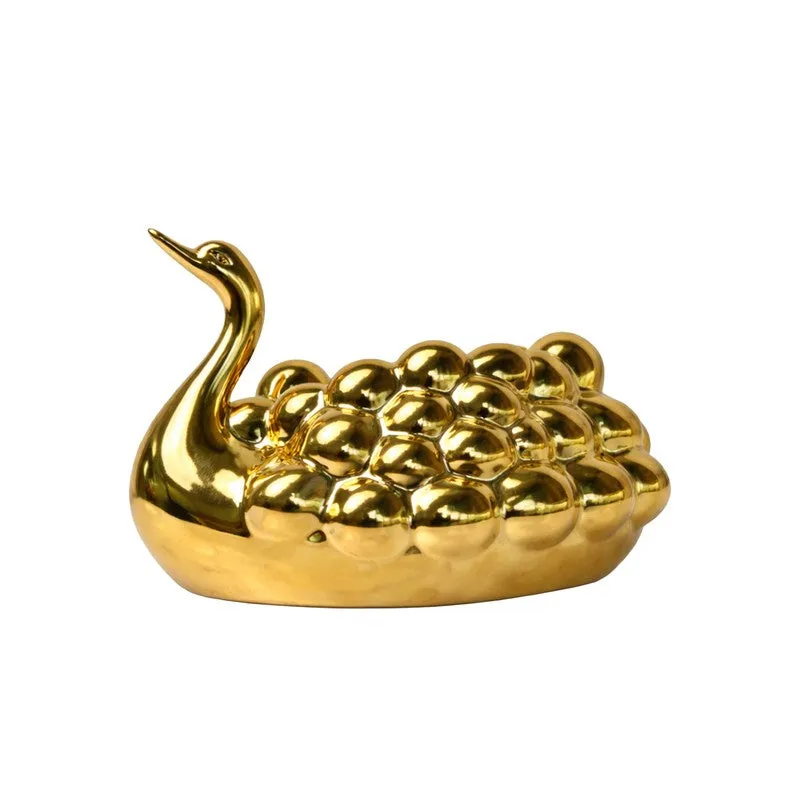 Gold ceramic swan-shaped tissue holder shown against a white background