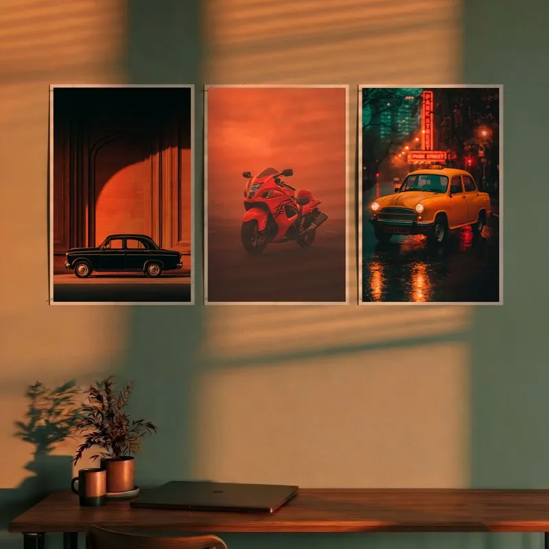 Set of three automotive wall posters above a desk in warm light