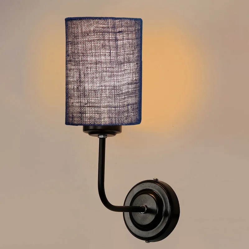 Close view of illuminated blue cylindrical jute wall lamp with black base