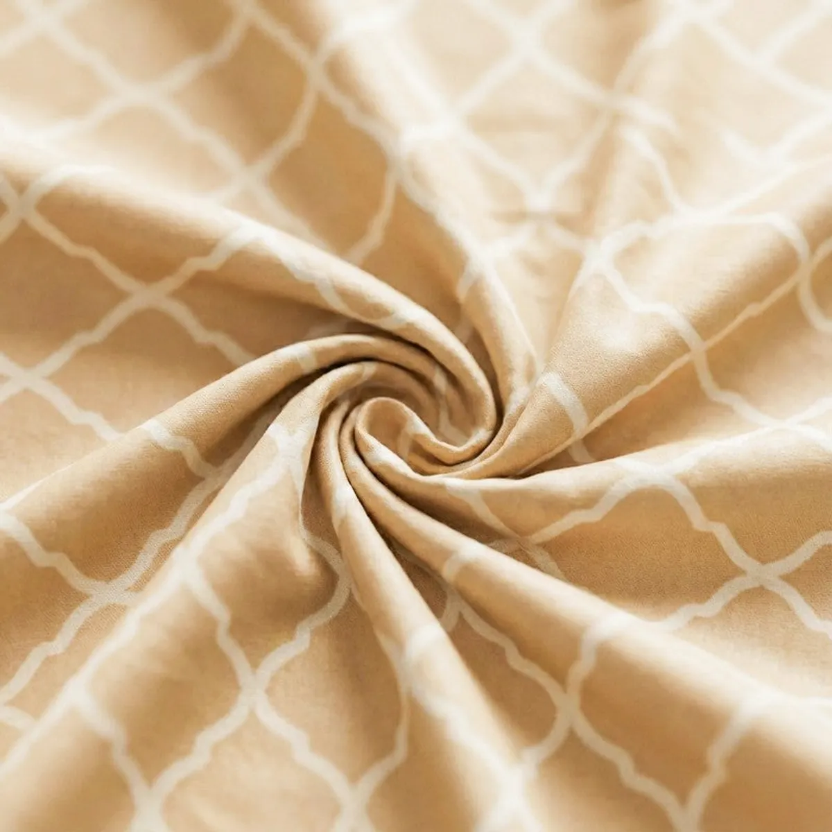 Detailed close-up of the yellow bedsheet fabric with white geometric pattern
