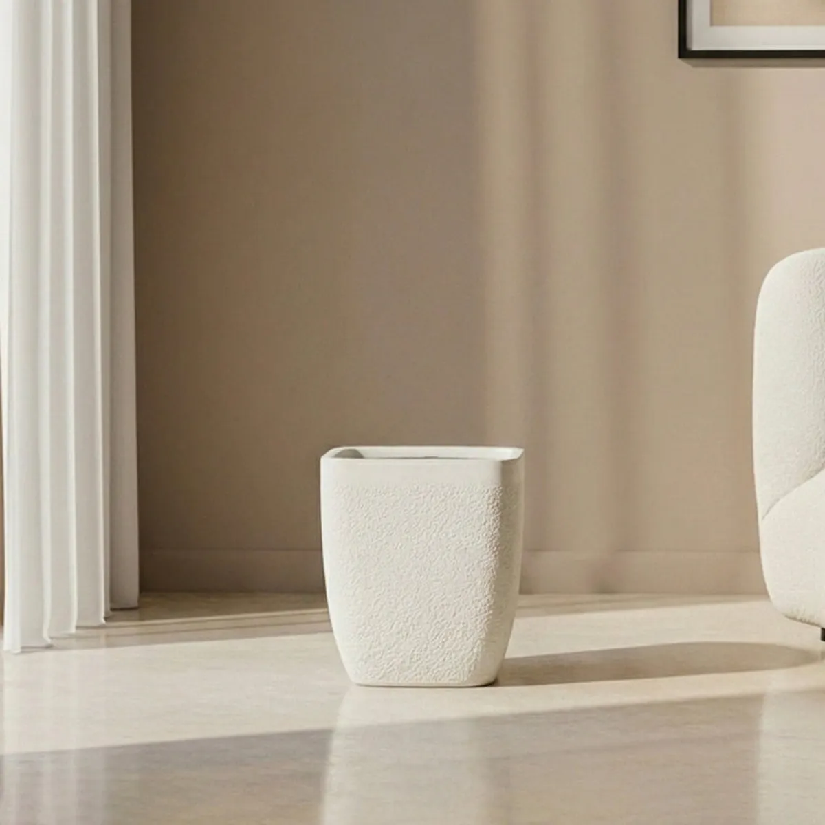 White square planter with rounded corners shown empty on a light floor