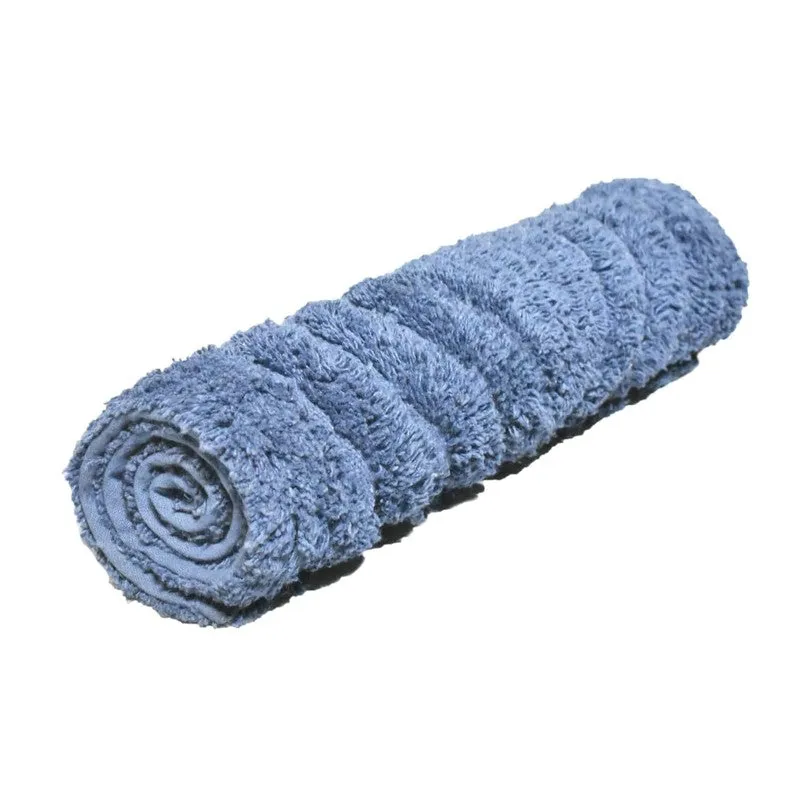 Blue bath mat rolled into a cylinder, showing its soft textured surface