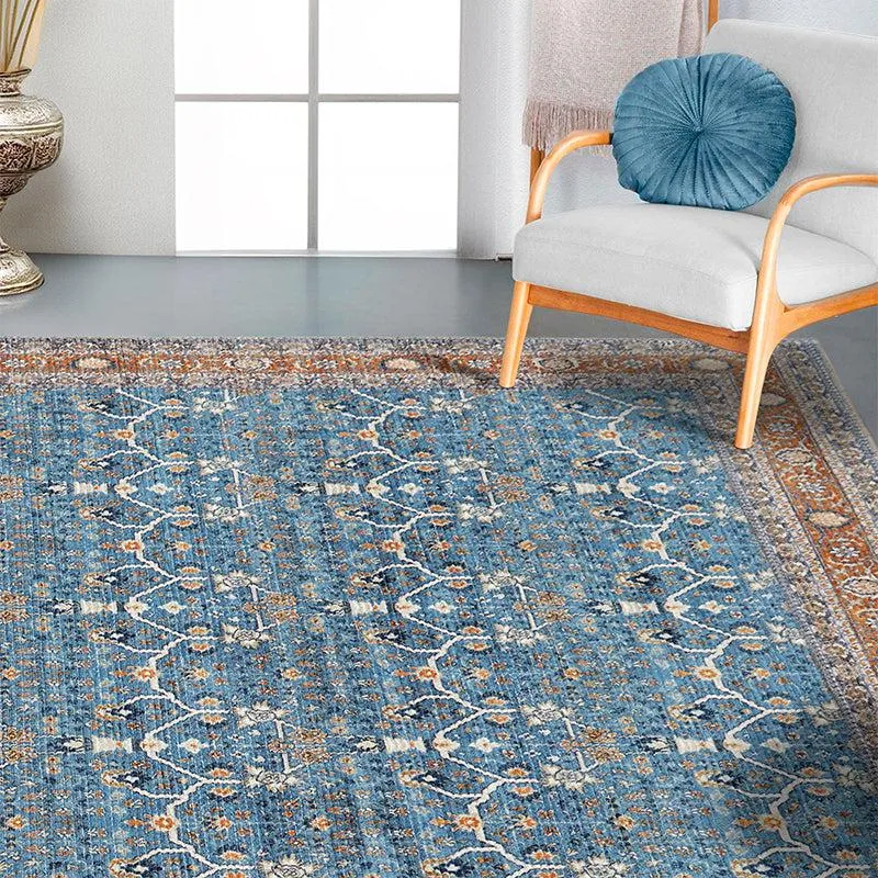 Blue ethnic-pattern carpet styled beside a light armchair