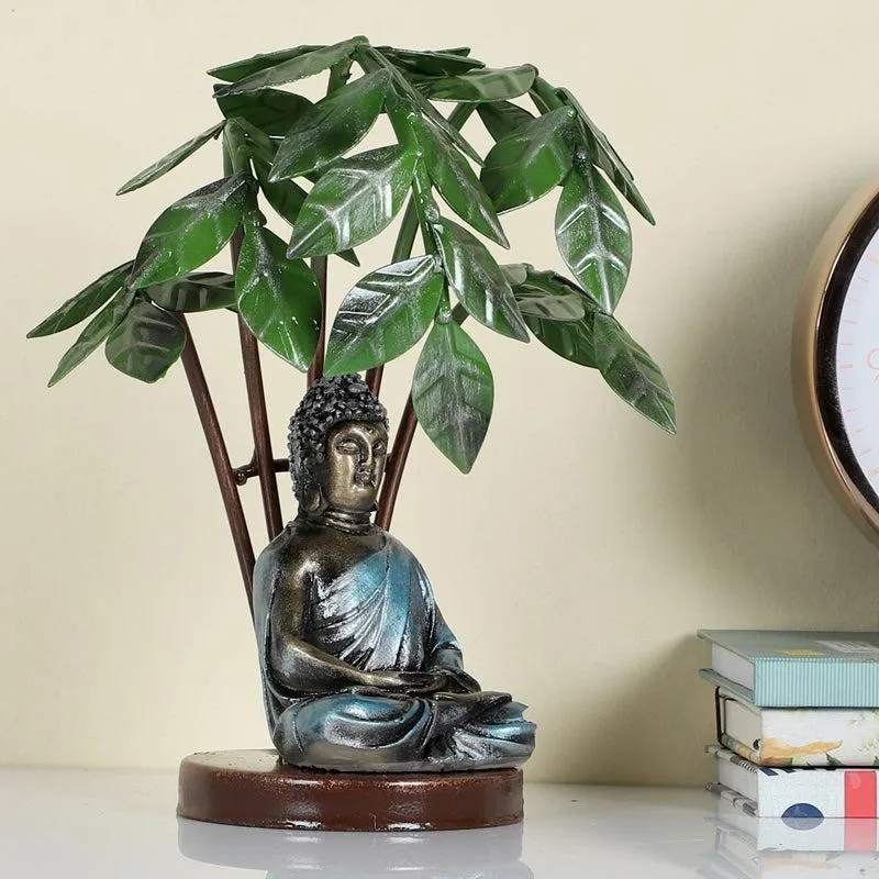 Buddha and Bodhi tree showpiece on a shelf with books nearby