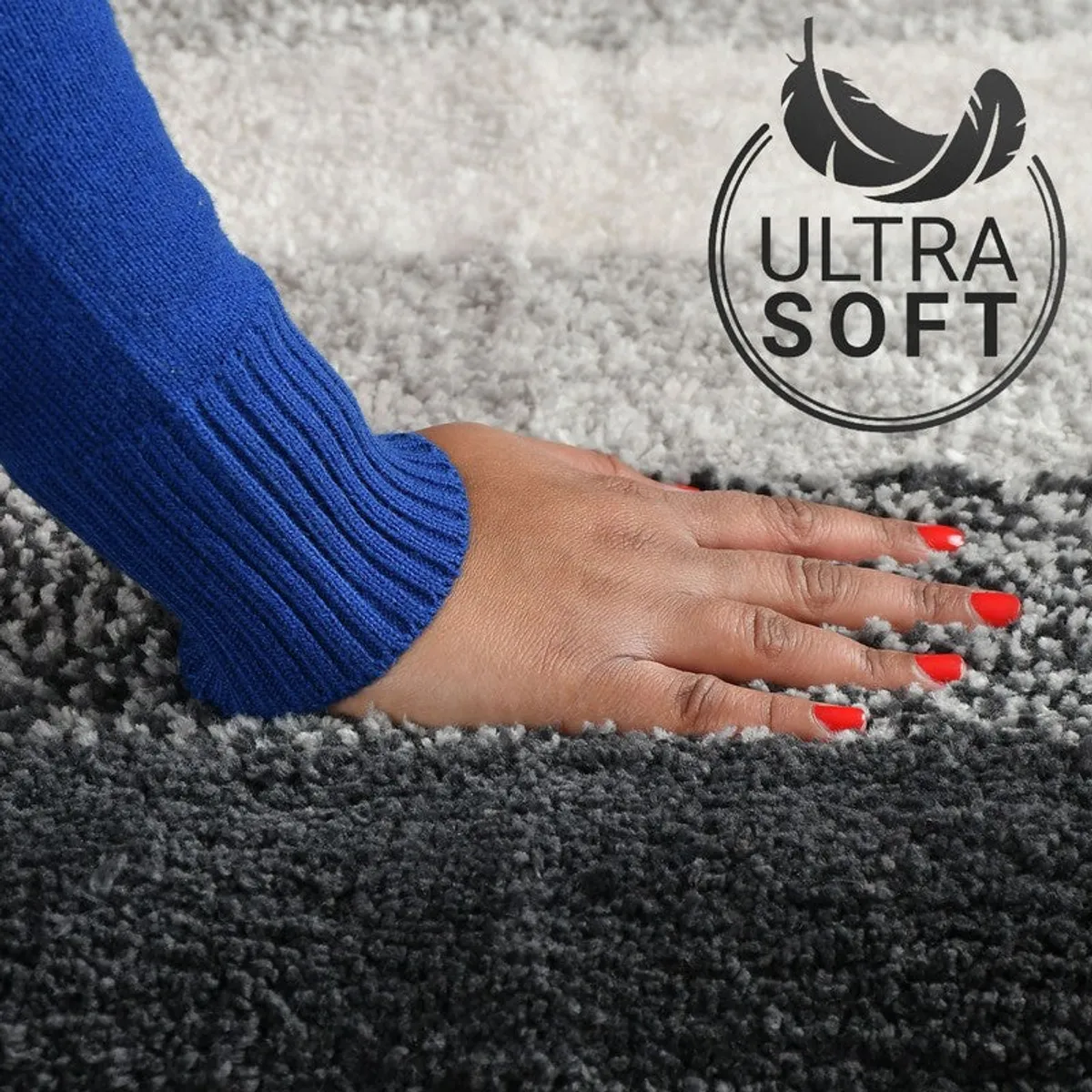 Hand touching the soft textured surface of the black and grey bath mat