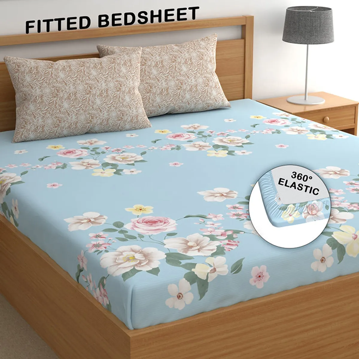 Blue floral fitted bedsheet on bed with elastic corner detail shown