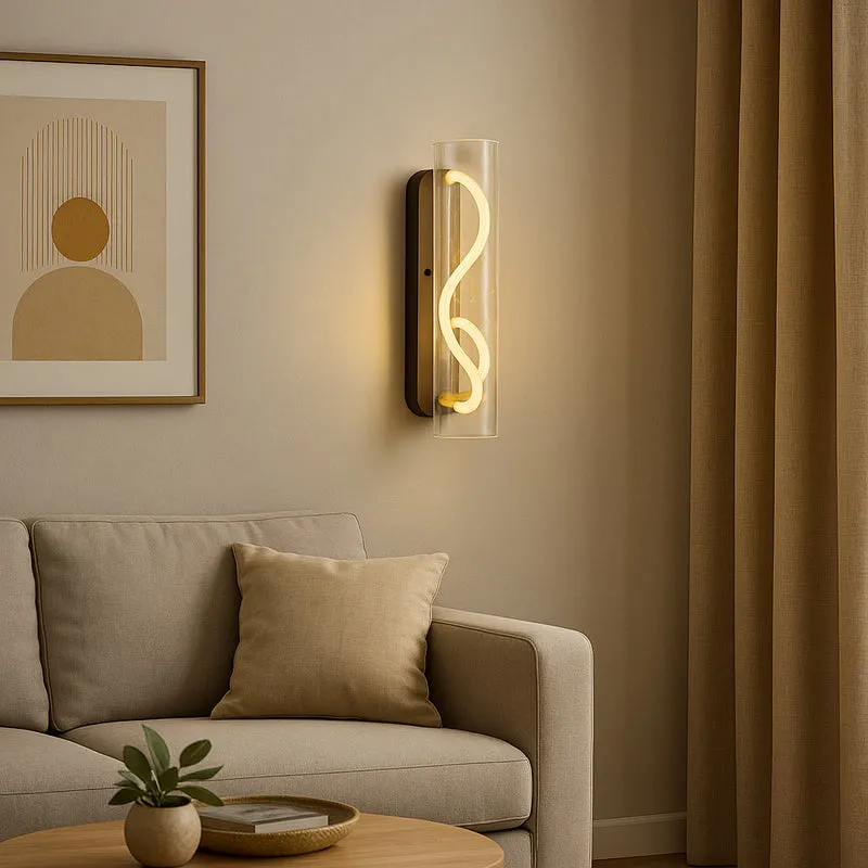 Black and transparent wall lamp glowing beside a framed print and beige sofa