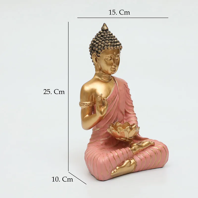 Angled view of seated pink and gold Buddha idol