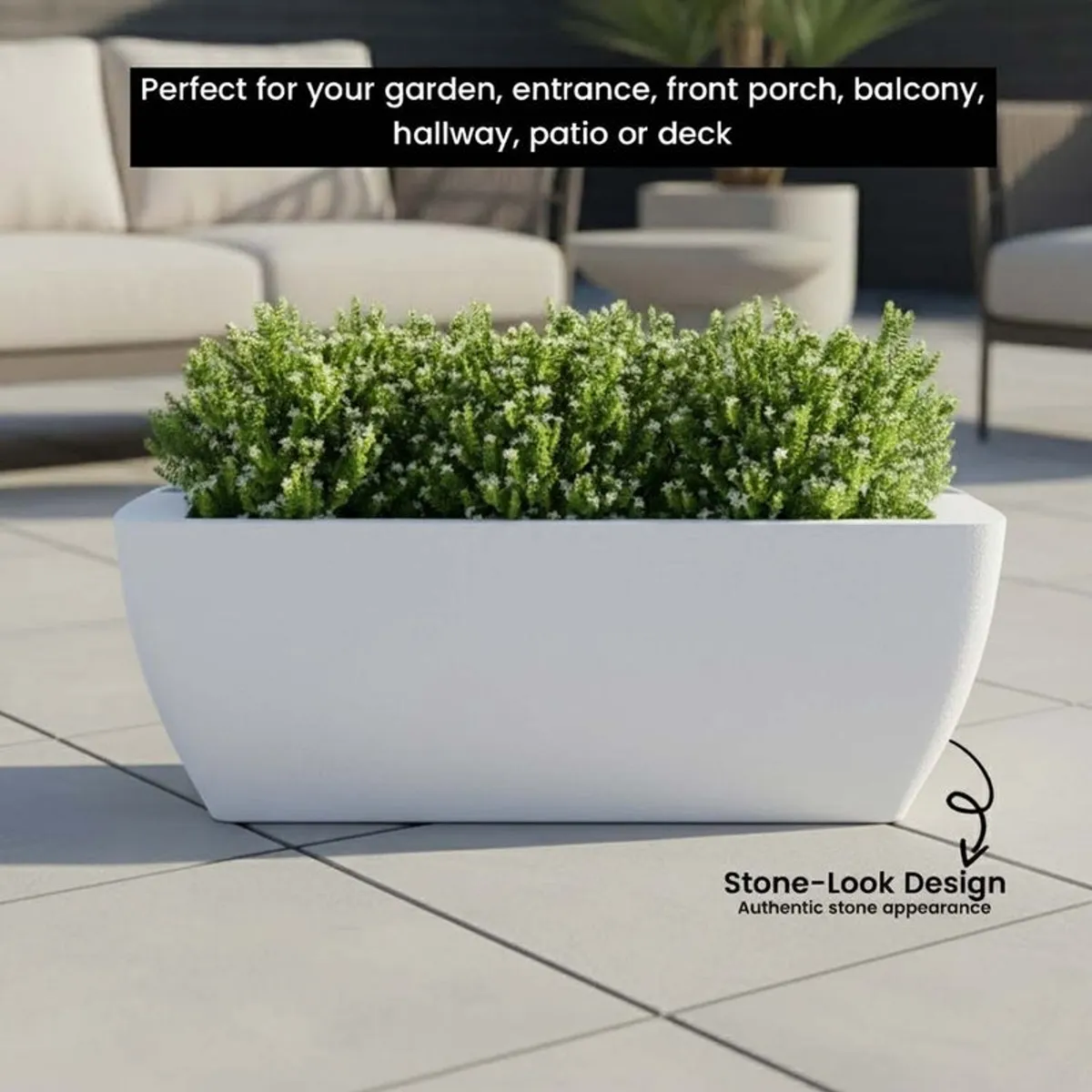White planter with greenery outdoors, showing its stone-look appearance.