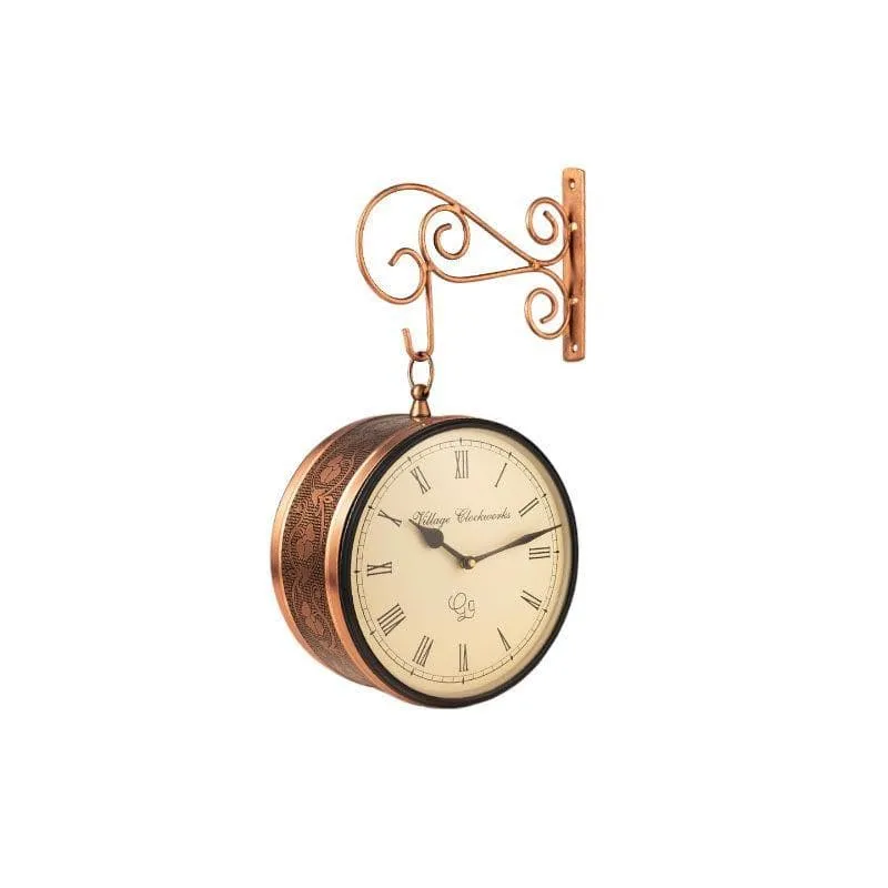 Side view of copper-toned double-sided clock with ornate patterned casing