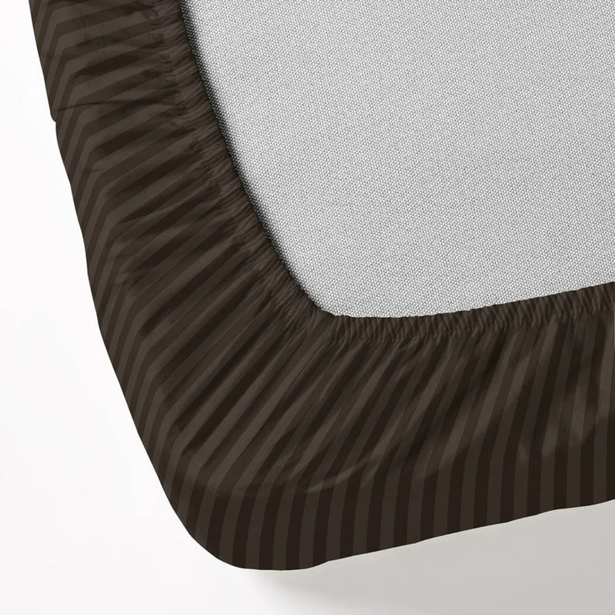Close-up of the brown striped fitted sheet corner and elasticated edge