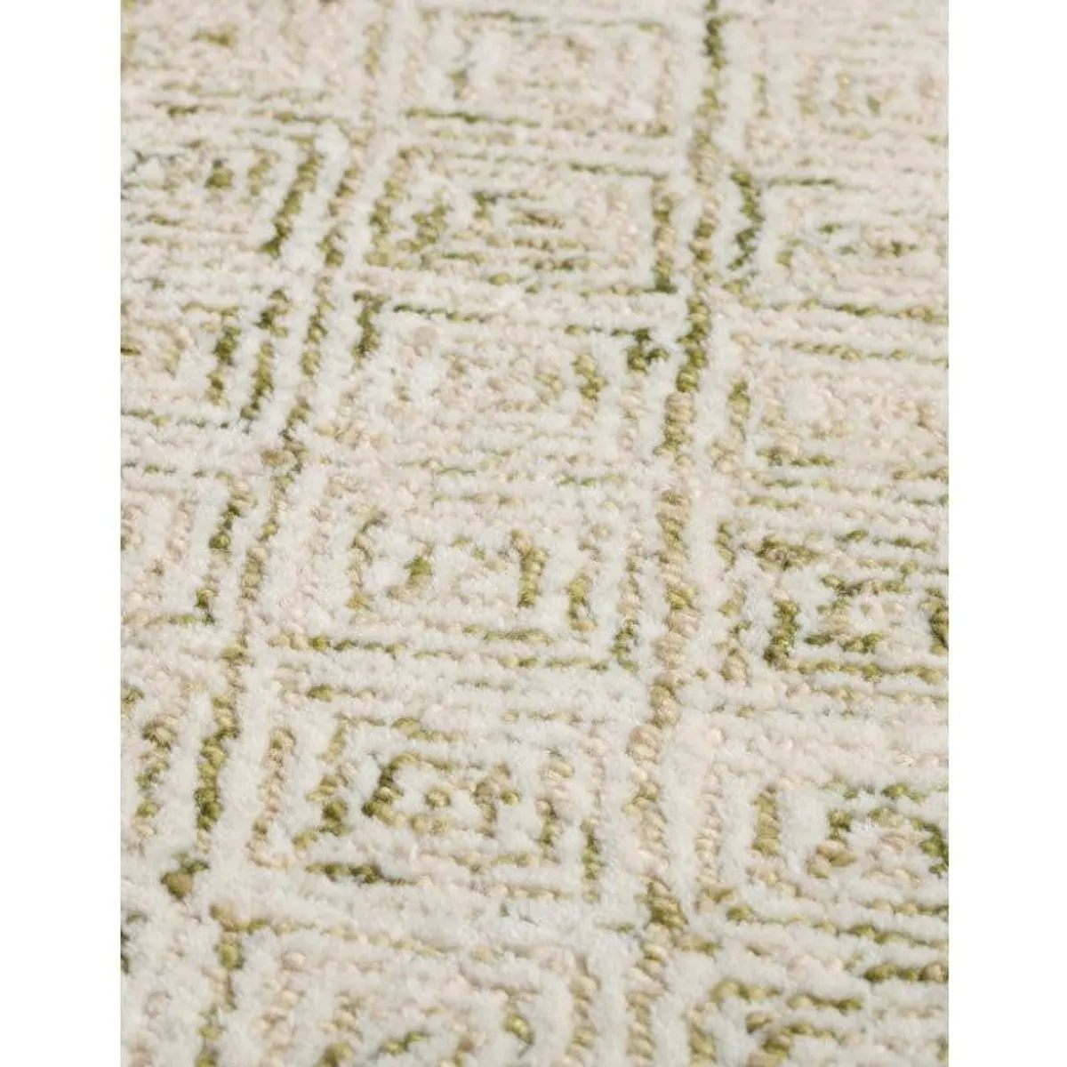 Close-up view of the rug's raised geometric texture in olive and white
