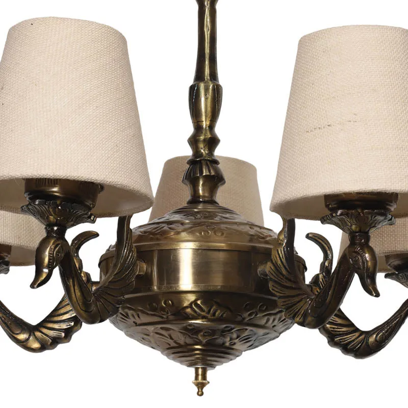 Close-up of the antique brass lamp body and beige fabric shades