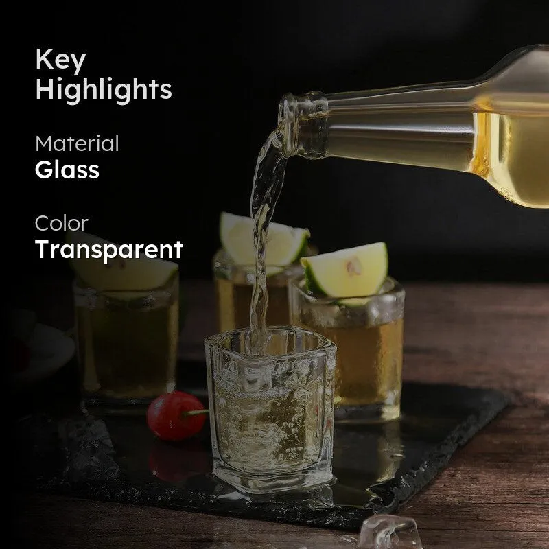 Transparent square shot glass being filled, styled with lime wedges
