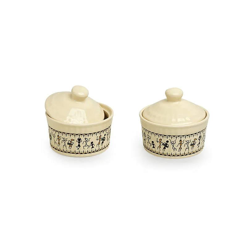 Two ivory ceramic jars with lids and tribal-style illustrated bands.