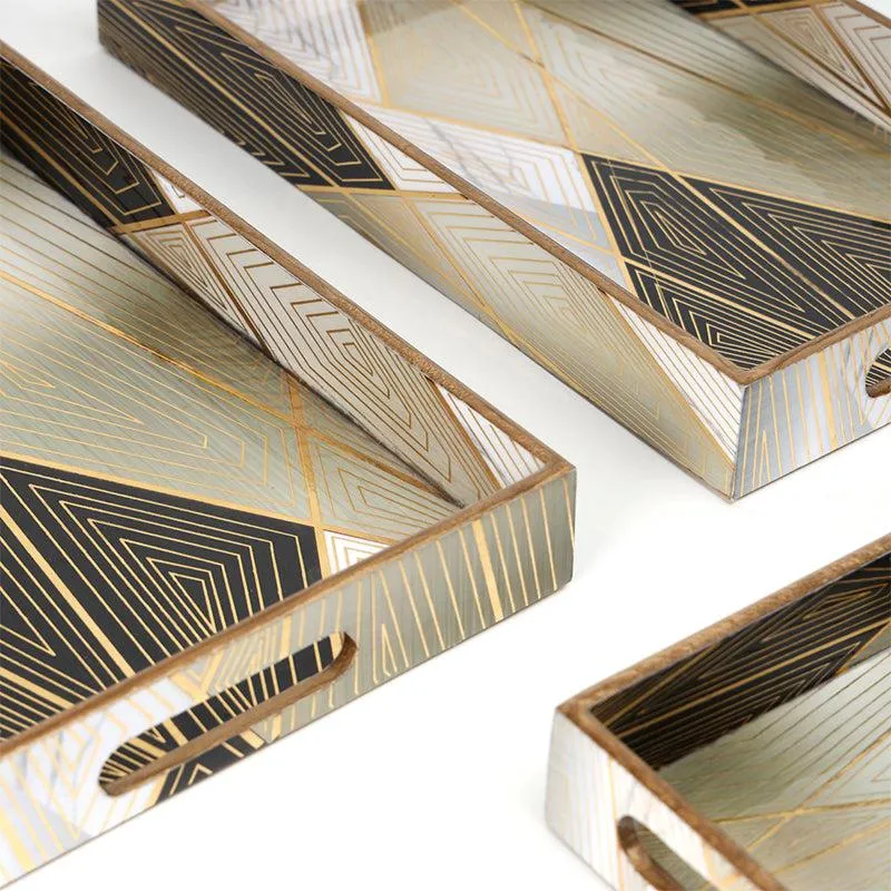 Close view of black and gold geometric patterns on the serving trays